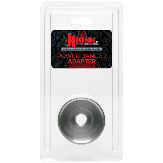 The image shows a product packaged in a clear plastic case with a label that reads 'KINK by Doc Johnson POWER BANGER ADAPTER'. The product itself appears to be a metallic, circular adapter designed for use with strokers and the Power Banger.