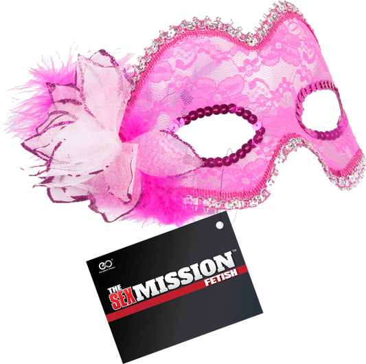 A pink masquerade mask with intricate details and a decorative flower, accompanied by a card that reads 'The Sex Mission Fetish'.