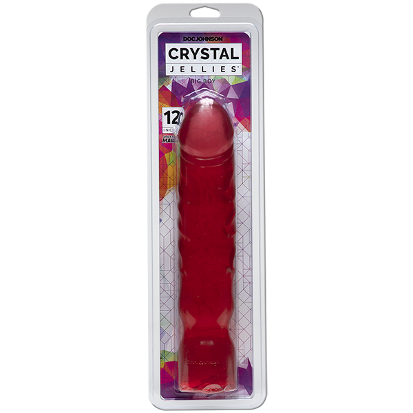 A clear, thick 12-inch dildo with a textured surface, packaged in a box. The box showcases the product in a pink hue and highlights its extra thick shaft and textured veins.